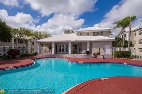 a view of a house with swimming pool and sitting area