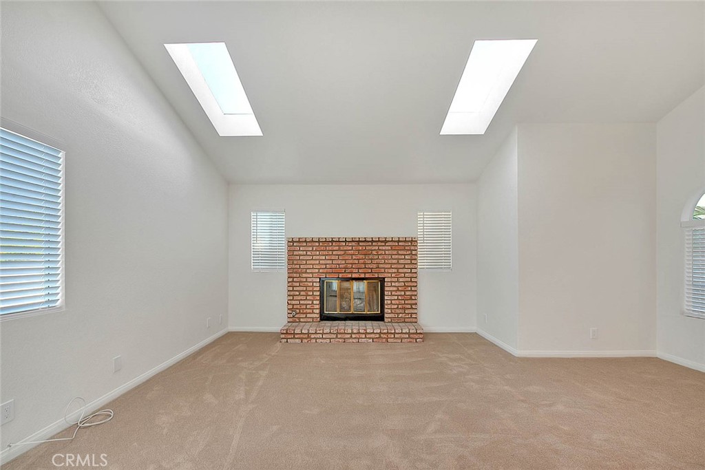 2015 Morgan Lane, Unit B Redondo Beach, CA 90278 - Photo 18 of 19 an empty room with a fireplace and windows