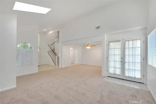 a view of empty room with a fireplace and window