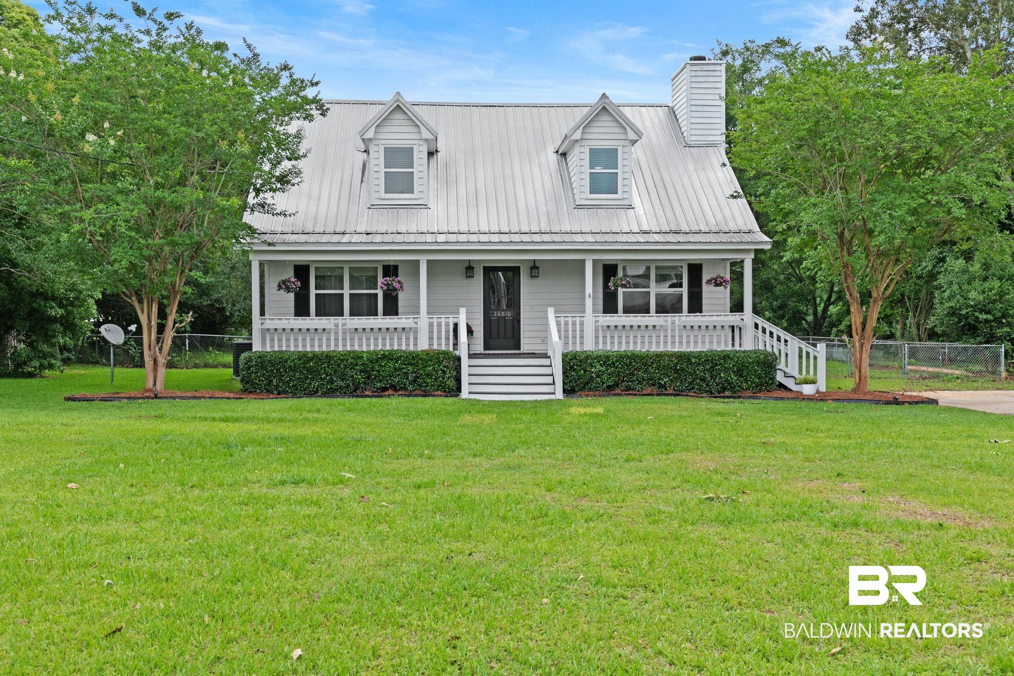22810 High Ridge Road Fairhope, AL 36532 - Photo 7 of 78 Charming exterior with a white metal roof, featuring a covered front porch with white railings and steps