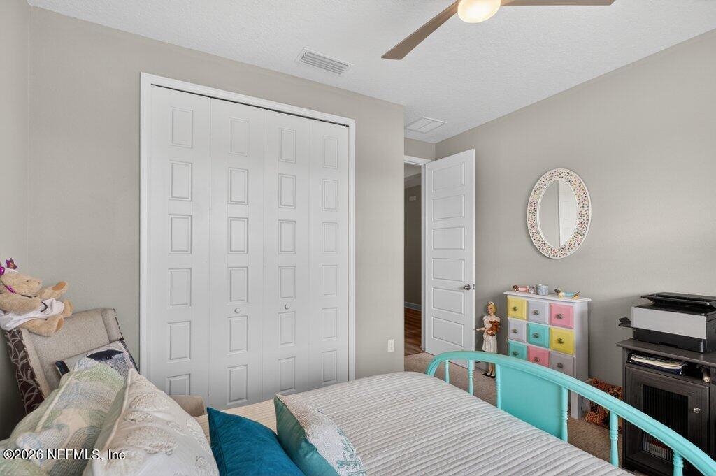 12 Wards Ravine Way St. Johns, FL 32259 - Photo 14 of 73 a bedroom with a bed a dresser and bookshelf