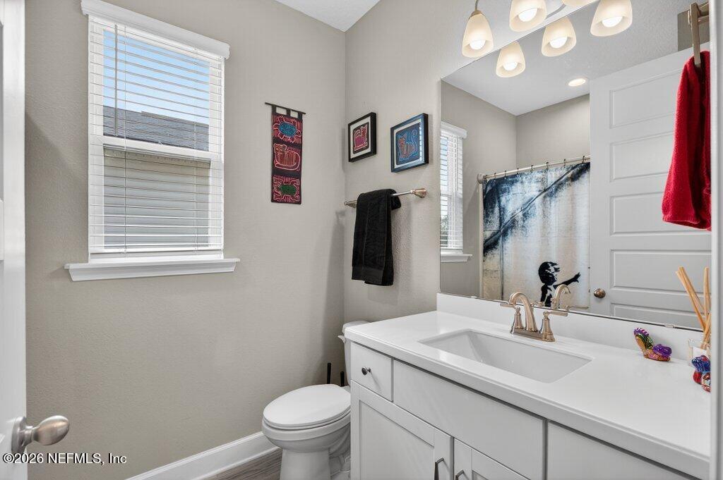 12 Wards Ravine Way St. Johns, FL 32259 - Photo 16 of 73 a bathroom with a sink a toilet and mirror