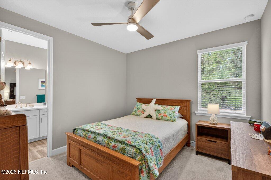 12 Wards Ravine Way St. Johns, FL 32259 - Photo 22 of 73 a bedroom with a large bed and a chandelier fan