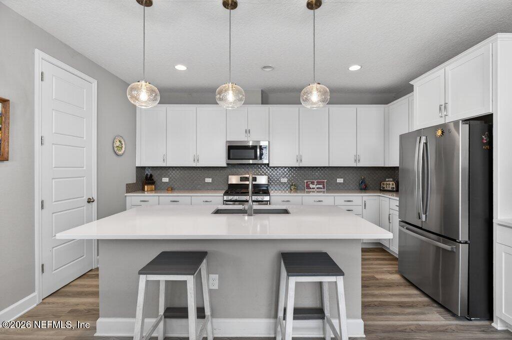 12 Wards Ravine Way St. Johns, FL 32259 - Photo 28 of 73 a kitchen with a center island and stainless steel appliances