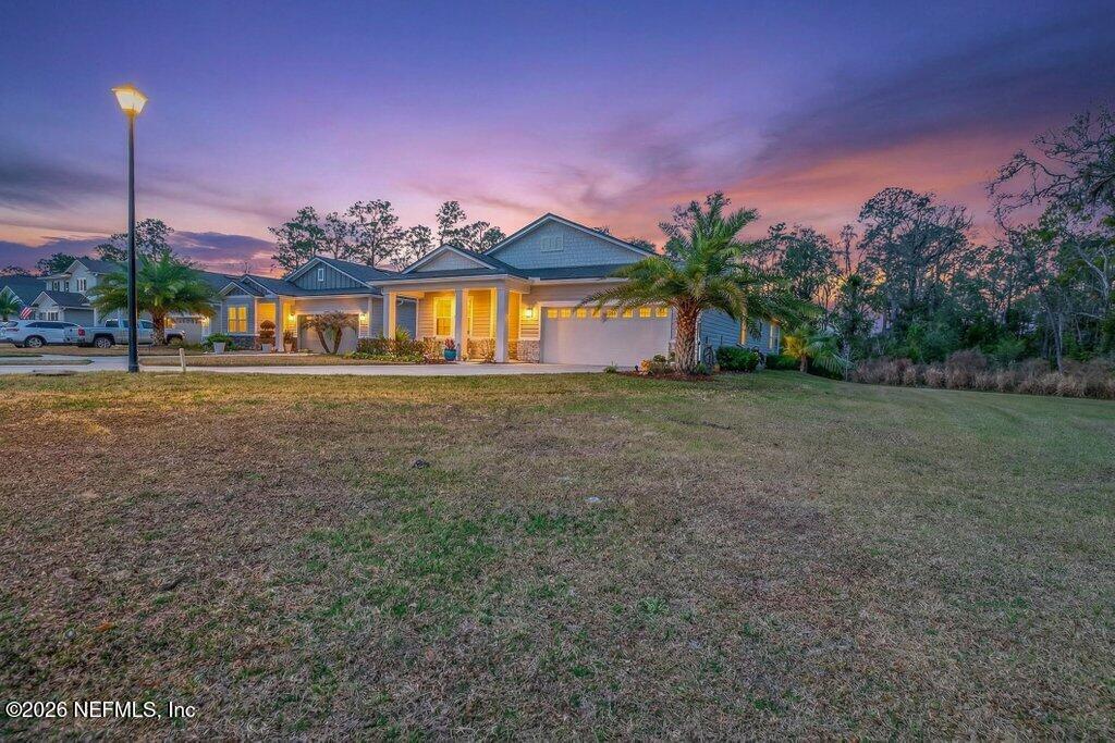 12 Wards Ravine Way St. Johns, FL 32259 - Photo 3 of 73 a front view of a house with a yard and a garage