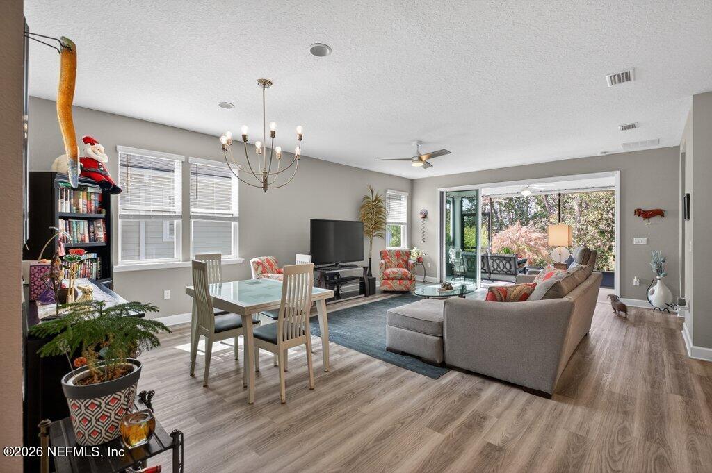 12 Wards Ravine Way St. Johns, FL 32259 - Photo 35 of 73 a living room with furniture a chandelier and a flat screen tv