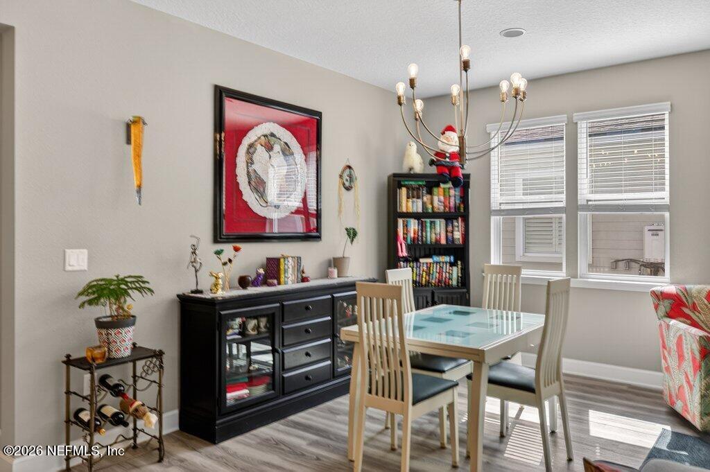 12 Wards Ravine Way St. Johns, FL 32259 - Photo 36 of 73 a view of a dining room with furniture window and wooden floor