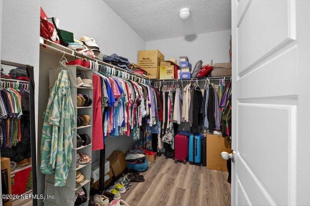 12 Wards Ravine Way St. Johns, FL 32259 - Photo 44 of 73 a view of walk in closet with clothes