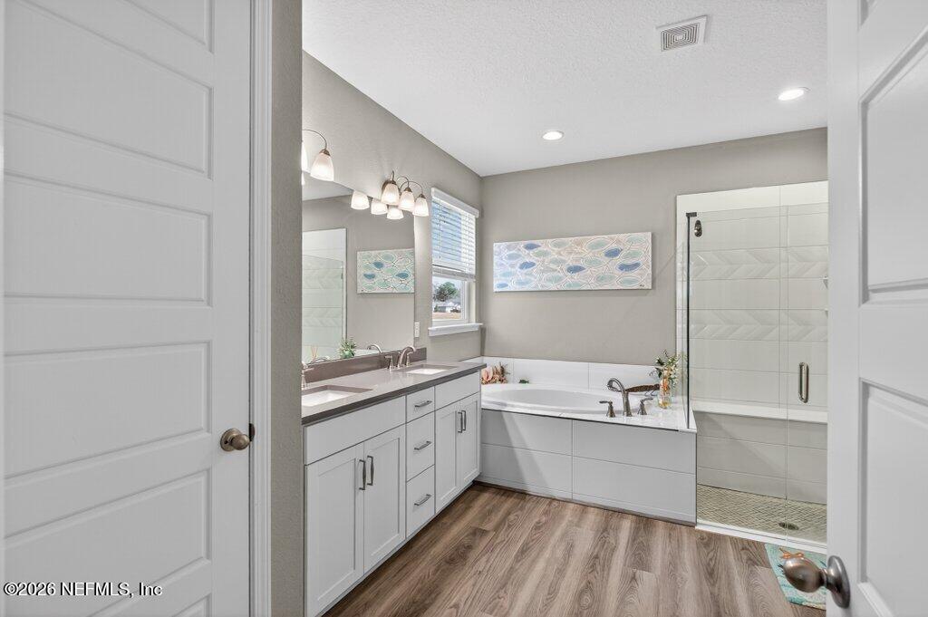 12 Wards Ravine Way St. Johns, FL 32259 - Photo 48 of 73 a bathroom with a tub a sink and mirrors