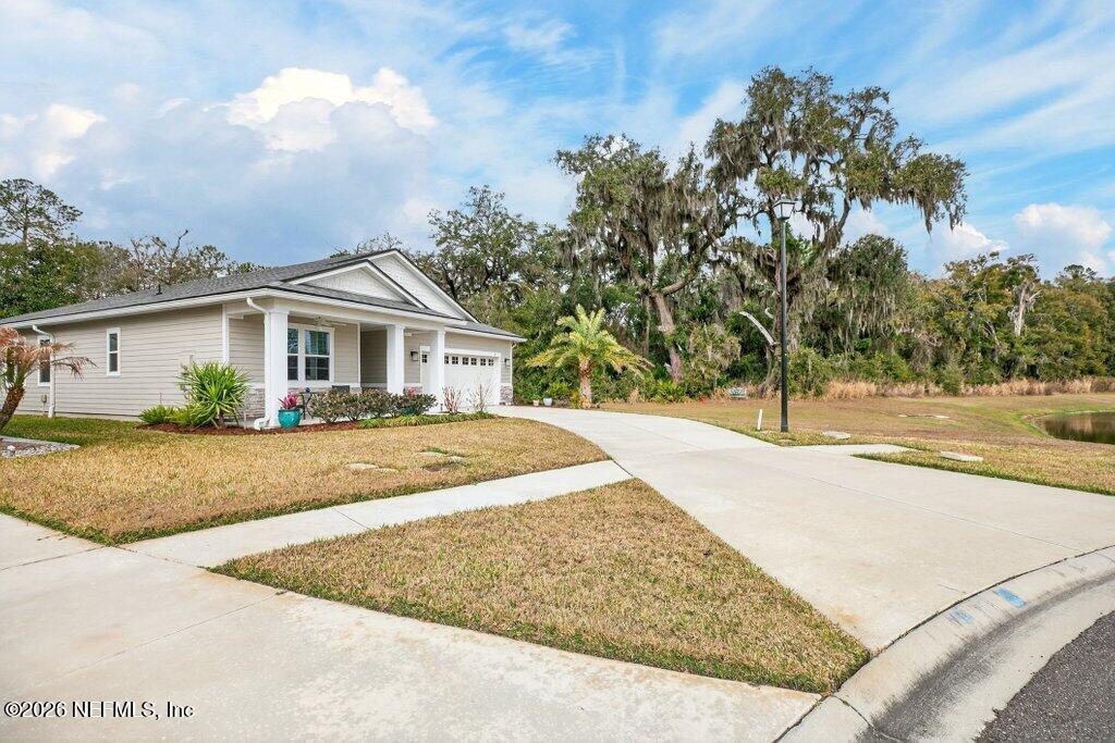 12 Wards Ravine Way St. Johns, FL 32259 - Photo 7 of 73 a view of house with yard and trees in the background