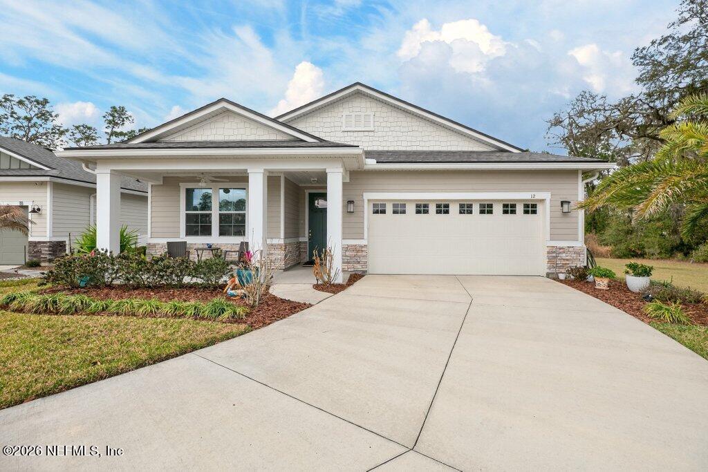 12 Wards Ravine Way St. Johns, FL 32259 - Photo 10 of 73 a front view of a house with a yard and potted plants