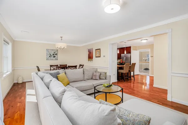 a living room with furniture and a wooden floor