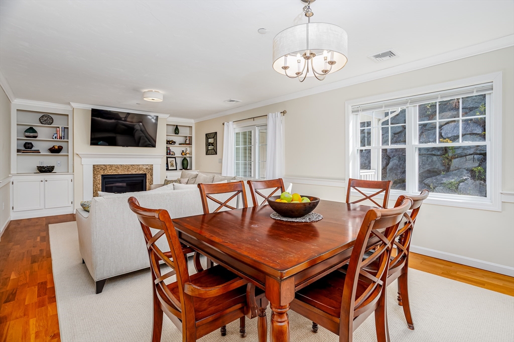 1221 Hazelwood Way, Unit 1221 Clinton, MA 01510 - Photo 13 of 42 a view of a dining room with furniture window and wooden floor