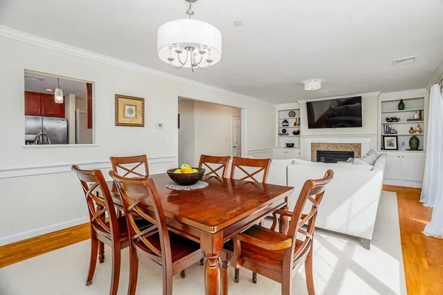 a view of a dining room with furniture wooden floor and a chandelier