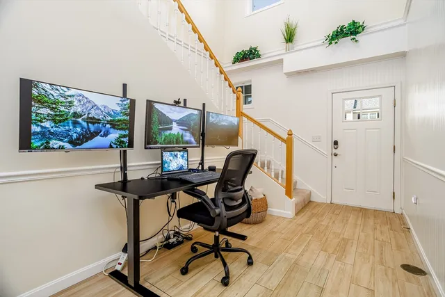 a view of a workspace with furniture window and wooden floor