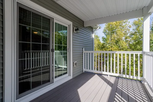 a view of a balcony with wooden floor