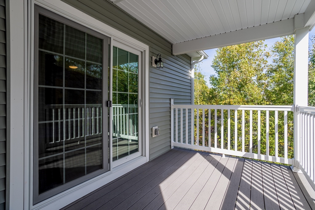 1221 Hazelwood Way, Unit 1221 Clinton, MA 01510 - Photo 29 of 42 a view of a balcony with wooden floor