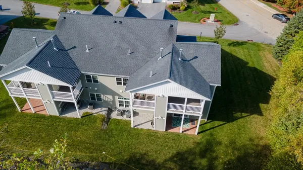 an aerial view of a house with a big yard and large trees