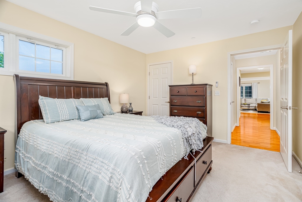 1221 Hazelwood Way, Unit 1221 Clinton, MA 01510 - Photo 33 of 42 a bedroom with a bed and a view of bathroom