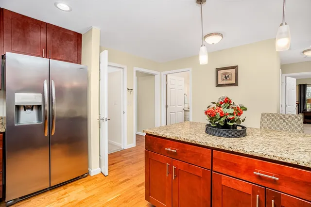a kitchen with stainless steel appliances granite countertop a refrigerator and a sink