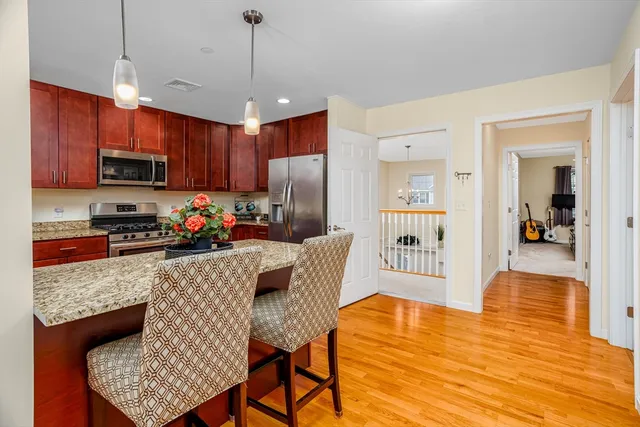 a kitchen with stainless steel appliances granite countertop a refrigerator a stove top oven a sink dishwasher and a refrigerator