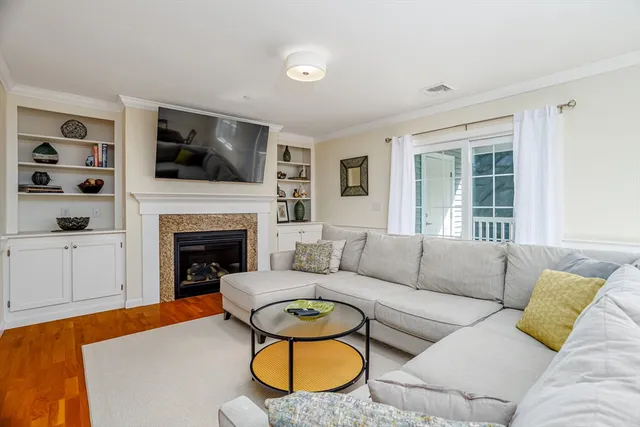 a living room with furniture fireplace and flat screen tv