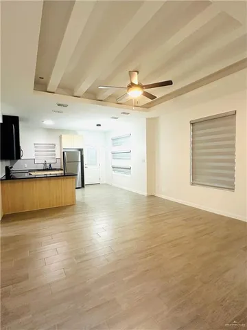 a view of a kitchen with a dishwasher and a stove top oven