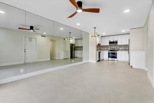 a view of a kitchen with a sink and a refrigerator