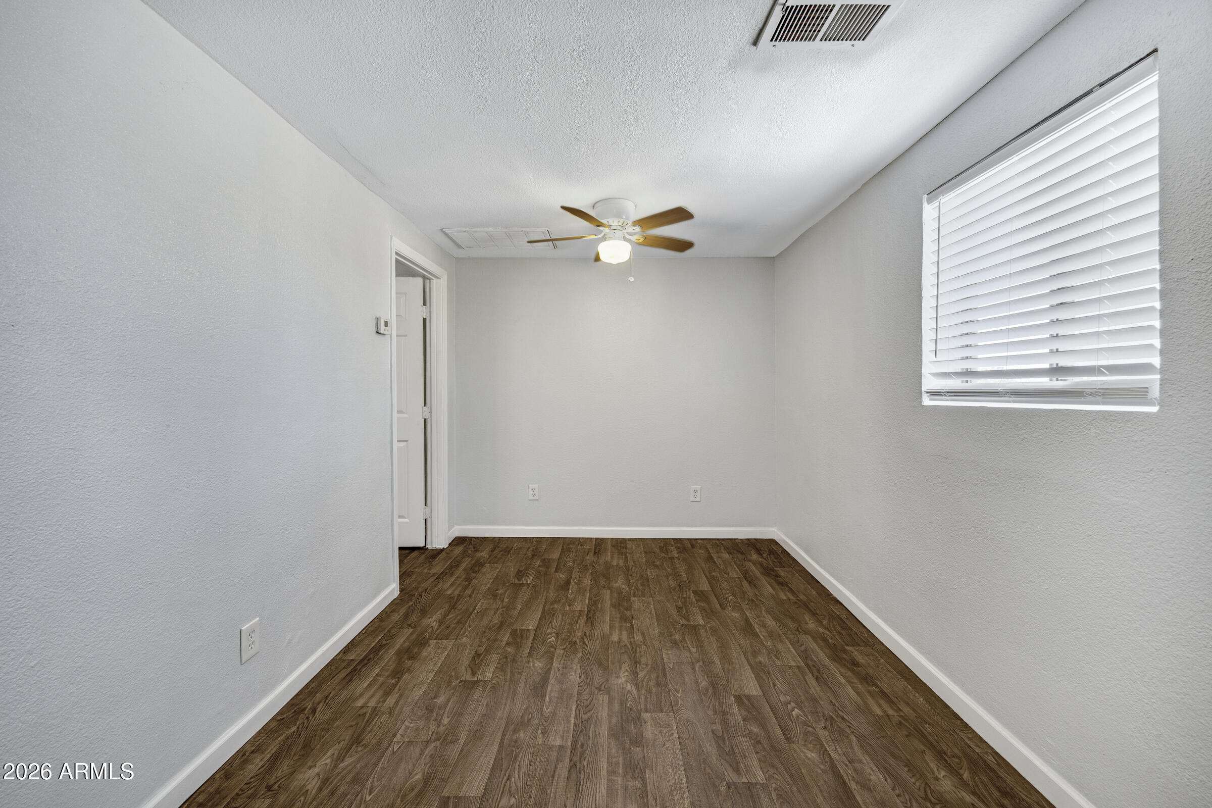 2238 East Taylor Street Phoenix, AZ 85006 - Photo 25 of 57 an empty room with a window and a ceiling fan