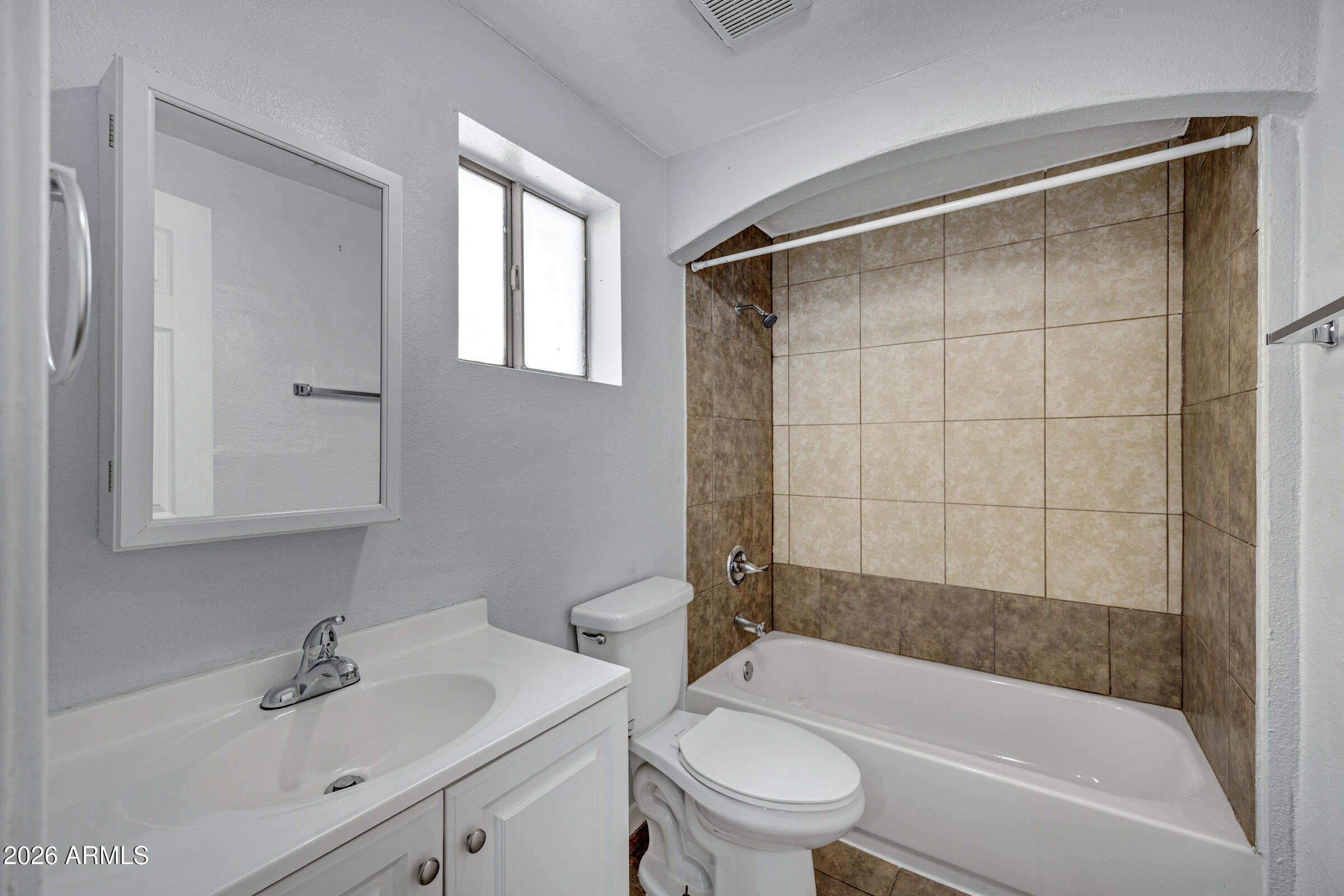2238 East Taylor Street Phoenix, AZ 85006 - Photo 30 of 57 a bathroom with a bathtub shower sink vanity and toilet