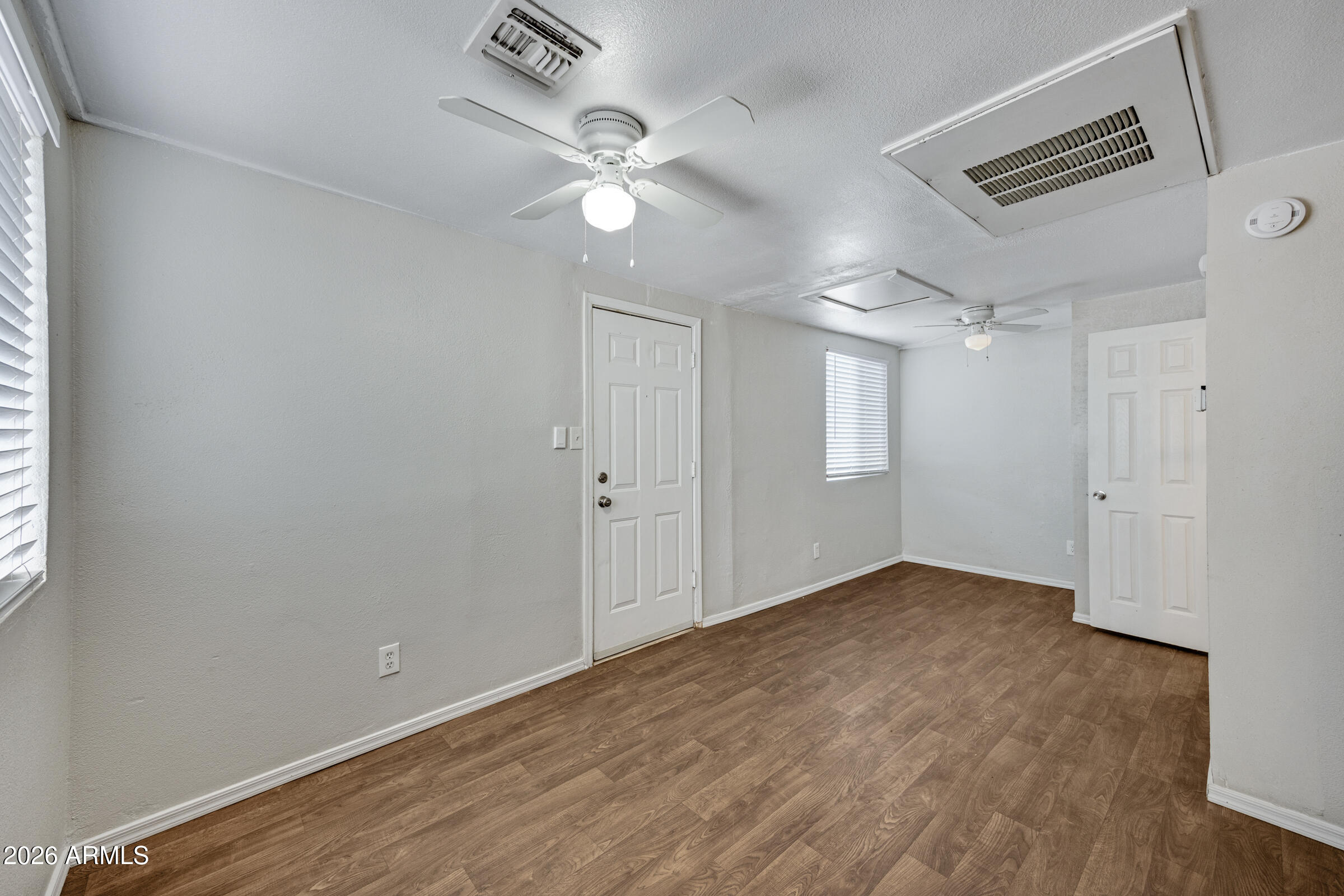 2238 East Taylor Street Phoenix, AZ 85006 - Photo 35 of 57 an empty room with wooden floor and fan