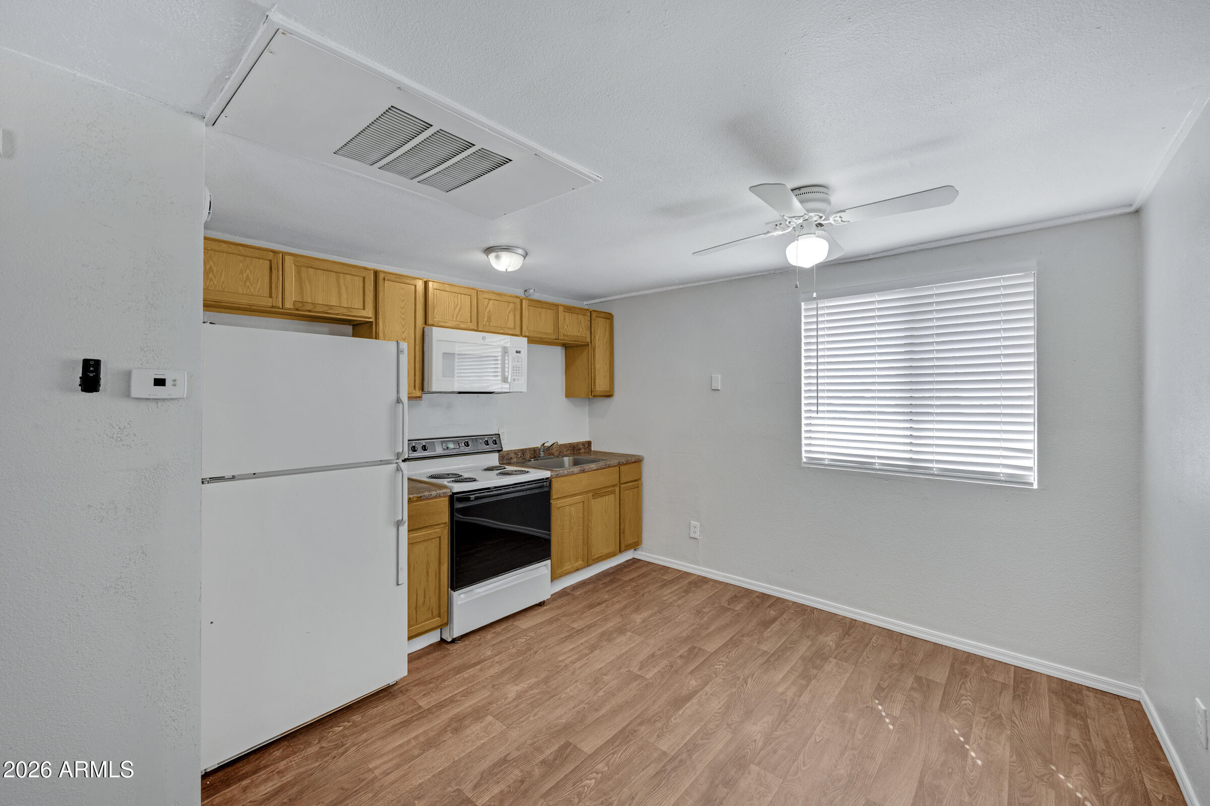 2238 East Taylor Street Phoenix, AZ 85006 - Photo 37 of 57 a kitchen with stainless steel appliances granite countertop a refrigerator a stove a sink and a microwave