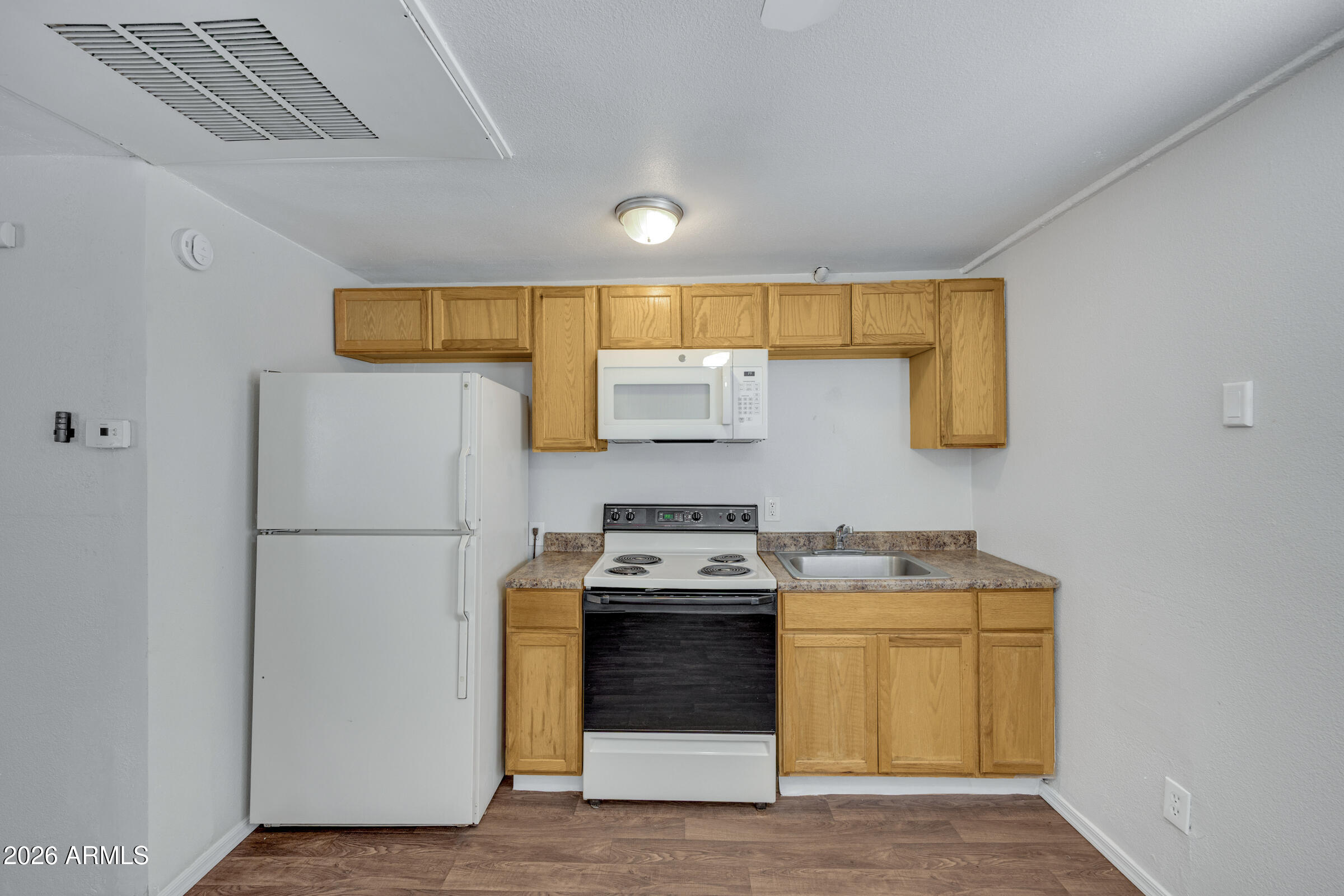 2238 East Taylor Street Phoenix, AZ 85006 - Photo 38 of 57 a kitchen with a stove a refrigerator and a sink