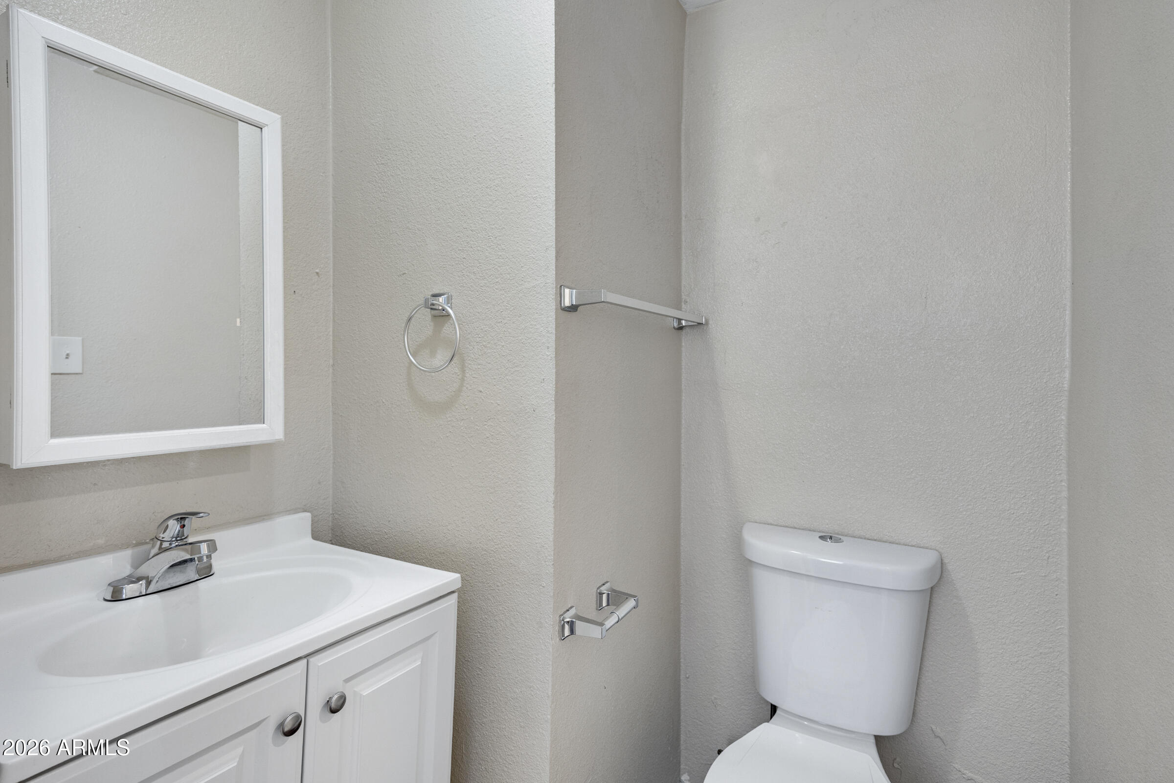 2238 East Taylor Street Phoenix, AZ 85006 - Photo 40 of 57 a bathroom with a toilet sink and mirror