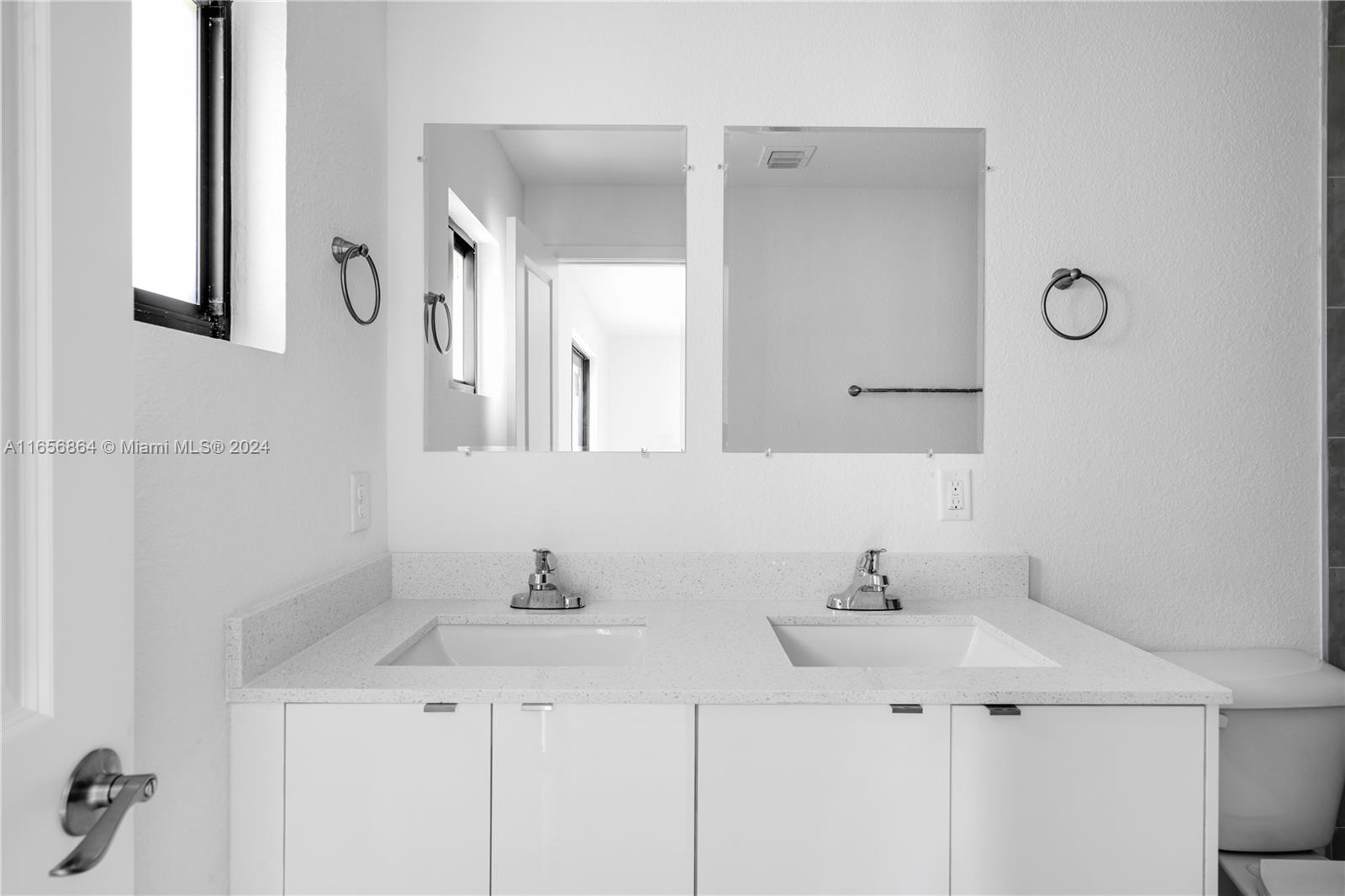 152 Northwest 18th Street Homestead, FL 33030 - Photo 12 of 28 a bathroom with a sink and a mirror