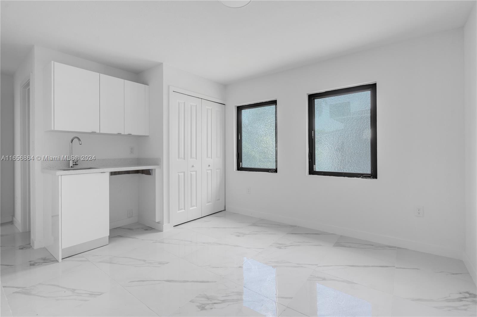 152 Northwest 18th Street Homestead, FL 33030 - Photo 13 of 28 a view of cabinets and white kitchen with sink