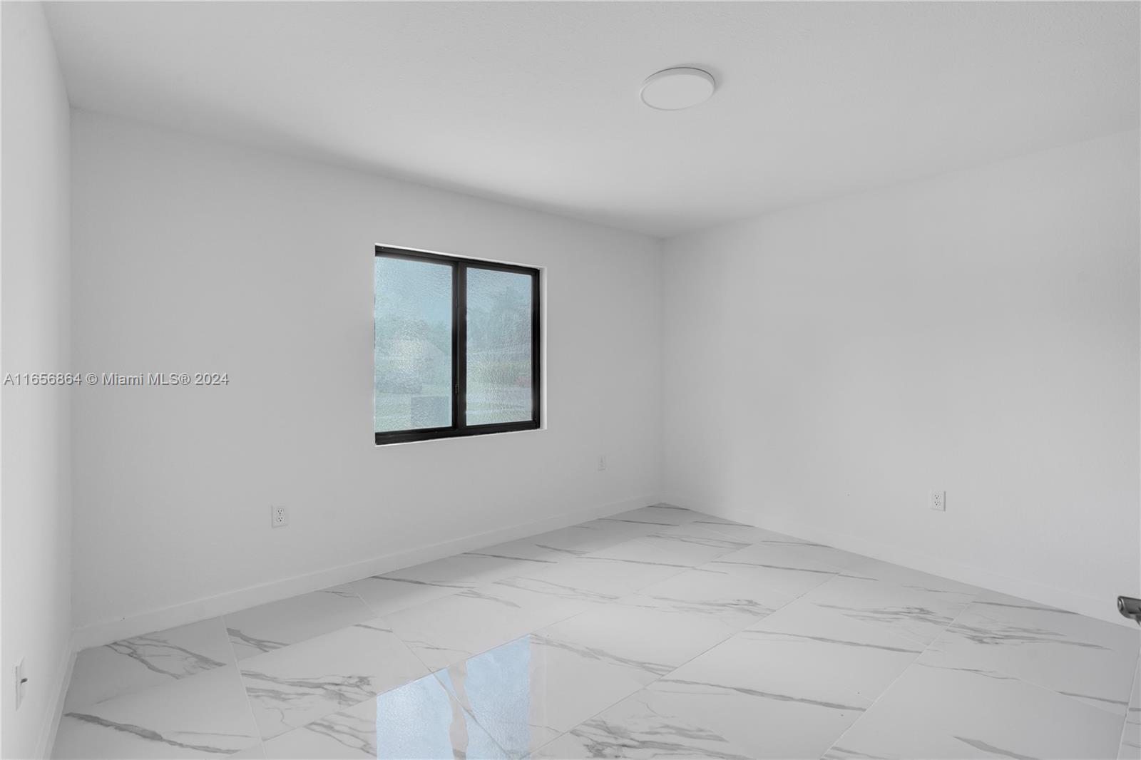 152 Northwest 18th Street Homestead, FL 33030 - Photo 19 of 28 an empty room with a window