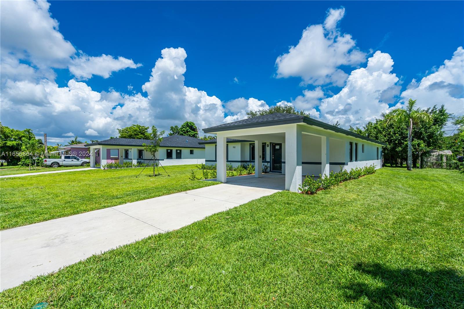 152 Northwest 18th Street Homestead, FL 33030 - Photo 3 of 28 a view of a house with a yard and garden