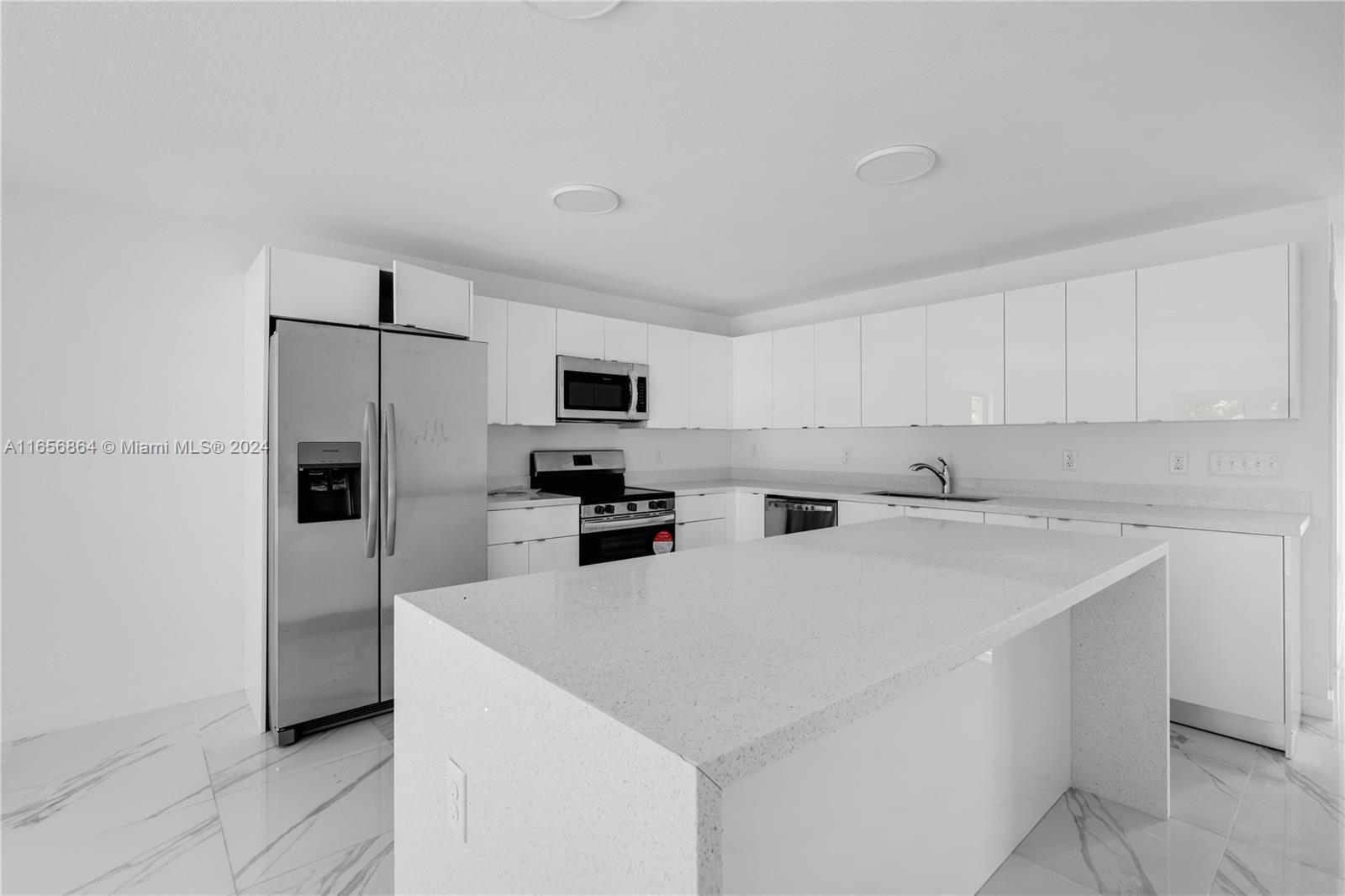 152 Northwest 18th Street Homestead, FL 33030 - Photo 4 of 28 a kitchen with stainless steel appliances a refrigerator sink and microwave