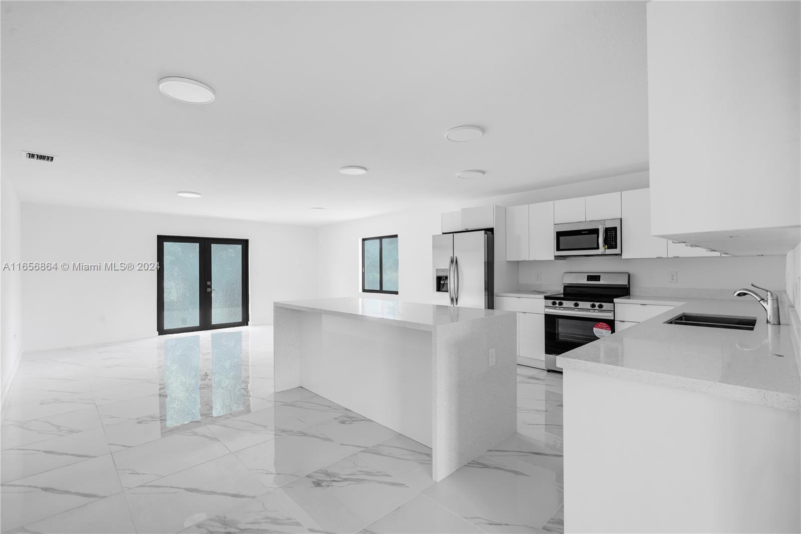 152 Northwest 18th Street Homestead, FL 33030 - Photo 6 of 28 a view of a kitchen with refrigerator and microwave