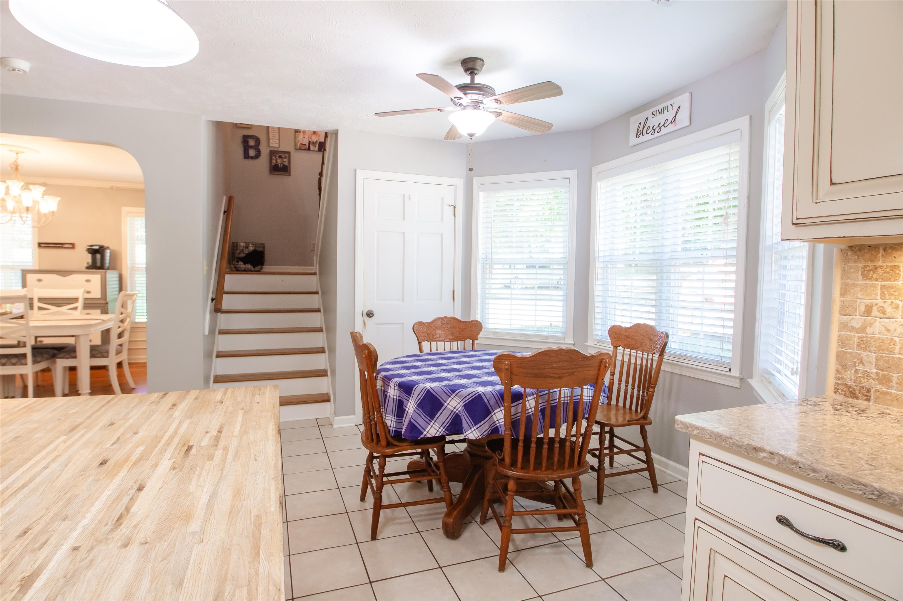 74 Huffman Road Brighton, TN 38011 - Photo 20 of 28 Dining space featuring light tile patterned flooring and ceiling fan with notable chandelier