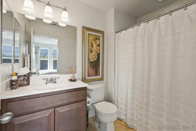 a bedroom with a bed and a painting