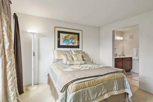 a bedroom with a bed and a large mirror