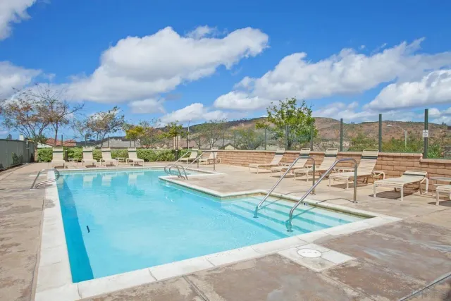 a view of a swimming pool with a lounge chairs