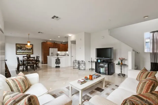 a view of kitchen with refrigerator and wooden floor