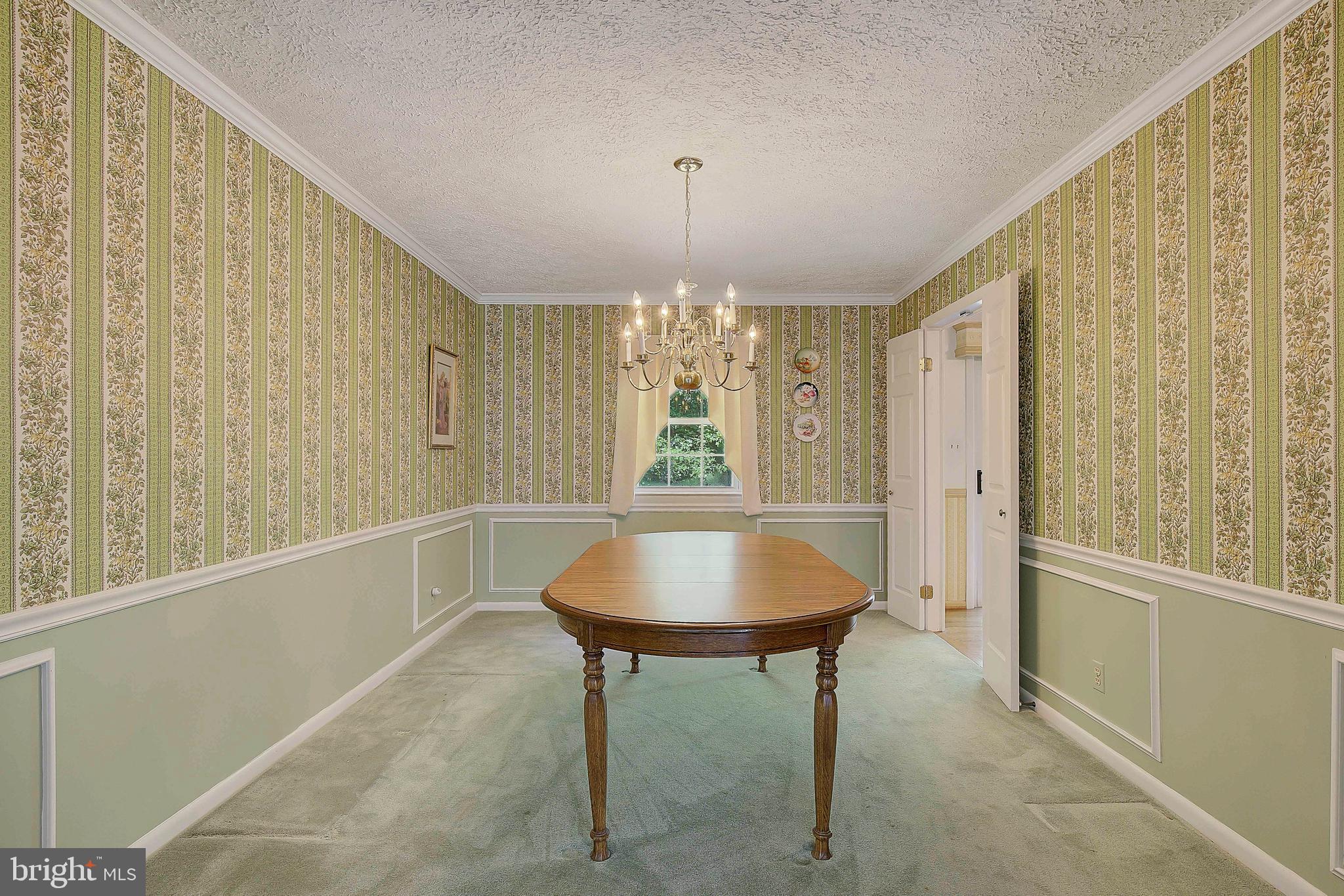 1750 Timber Court Huntingtown, MD 20639 - Photo 12 of 57 a living room with a table and a chandelier