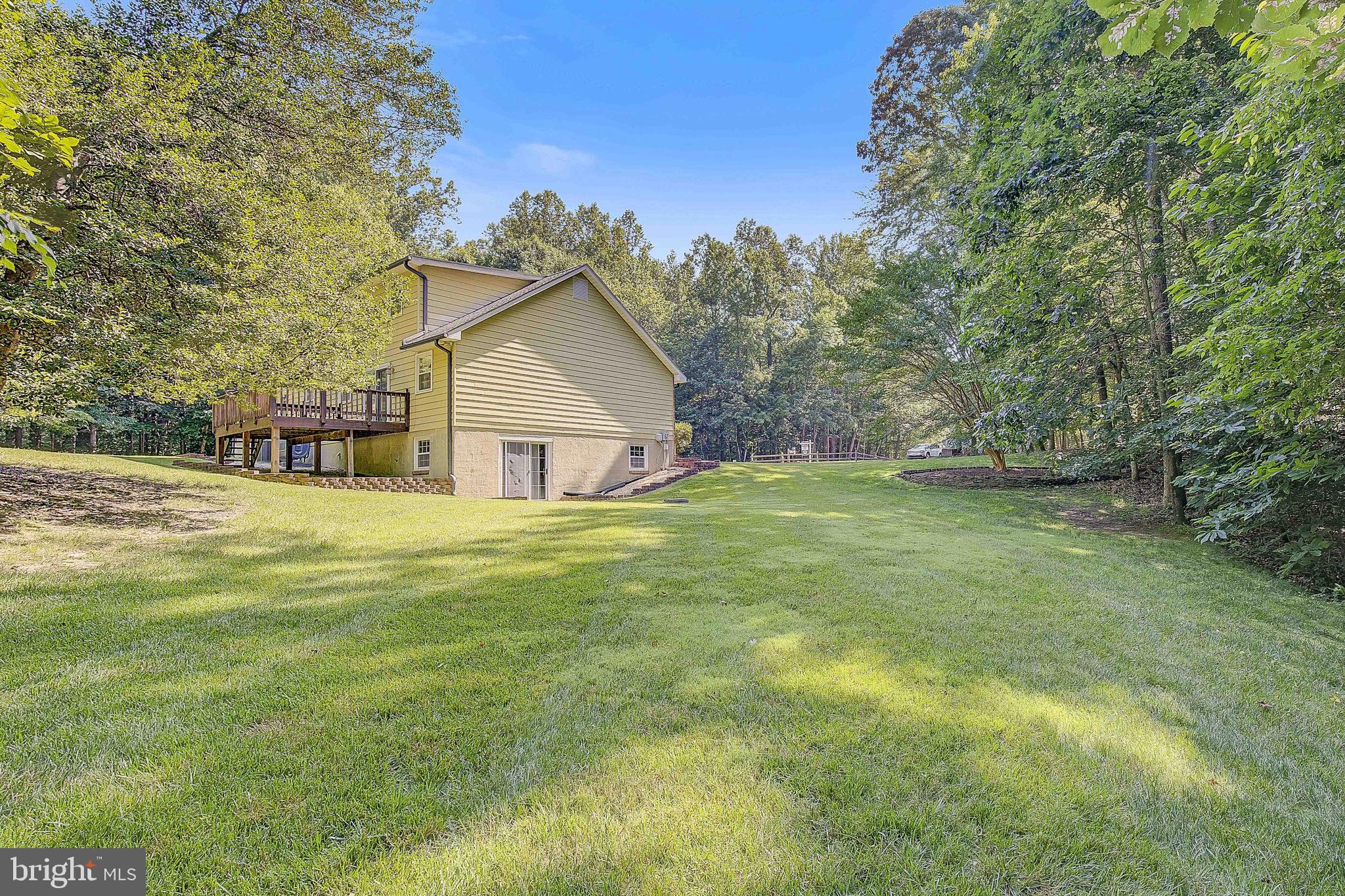 1750 Timber Court Huntingtown, MD 20639 - Photo 39 of 57 a house with huge green field with trees in the background