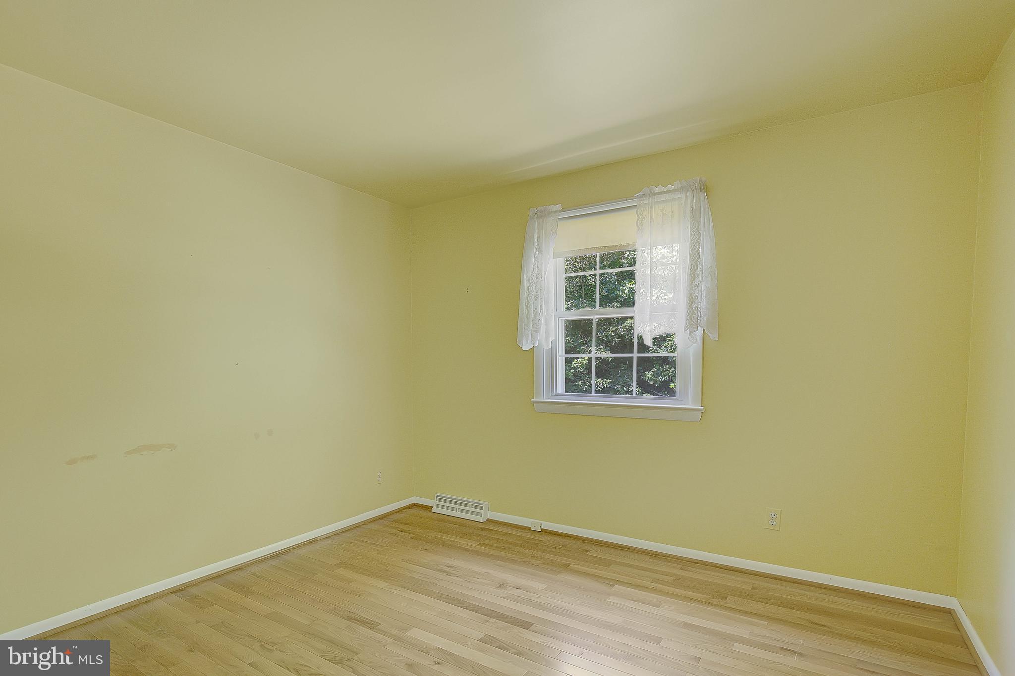 1750 Timber Court Huntingtown, MD 20639 - Photo 49 of 57 a view of an empty room with wooden floor and a window