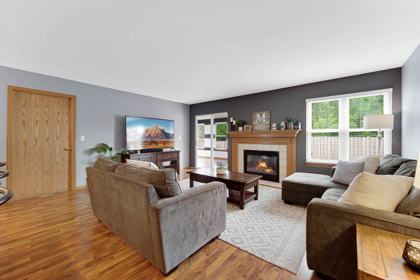 274 Spring Valley Way Round Lake, IL 60073 - Photo 7 of 28 a living room with furniture and a fireplace
