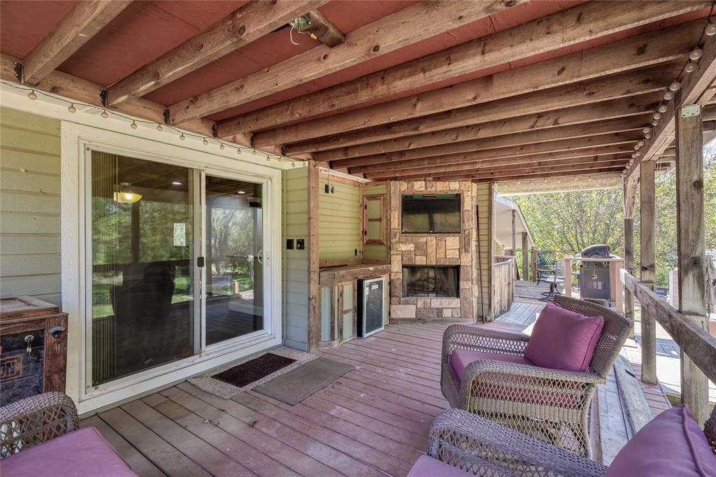 1701 Central Road Weatherford, TX 76088 - Photo 6 of 40 Deck featuring an outdoor stone fireplace and a grill